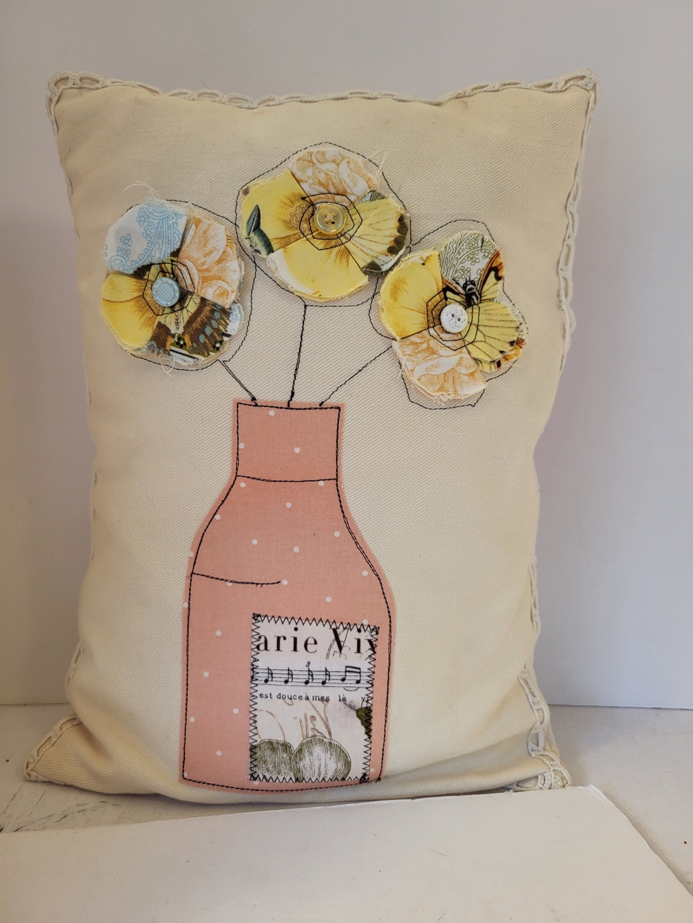 Decorative Cream Accent Pillow with Pink Bottle and Yellow Floral Appliqué
